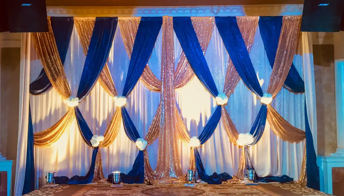 Royal blue and gold criss-cross backdrop · Dream Decorators