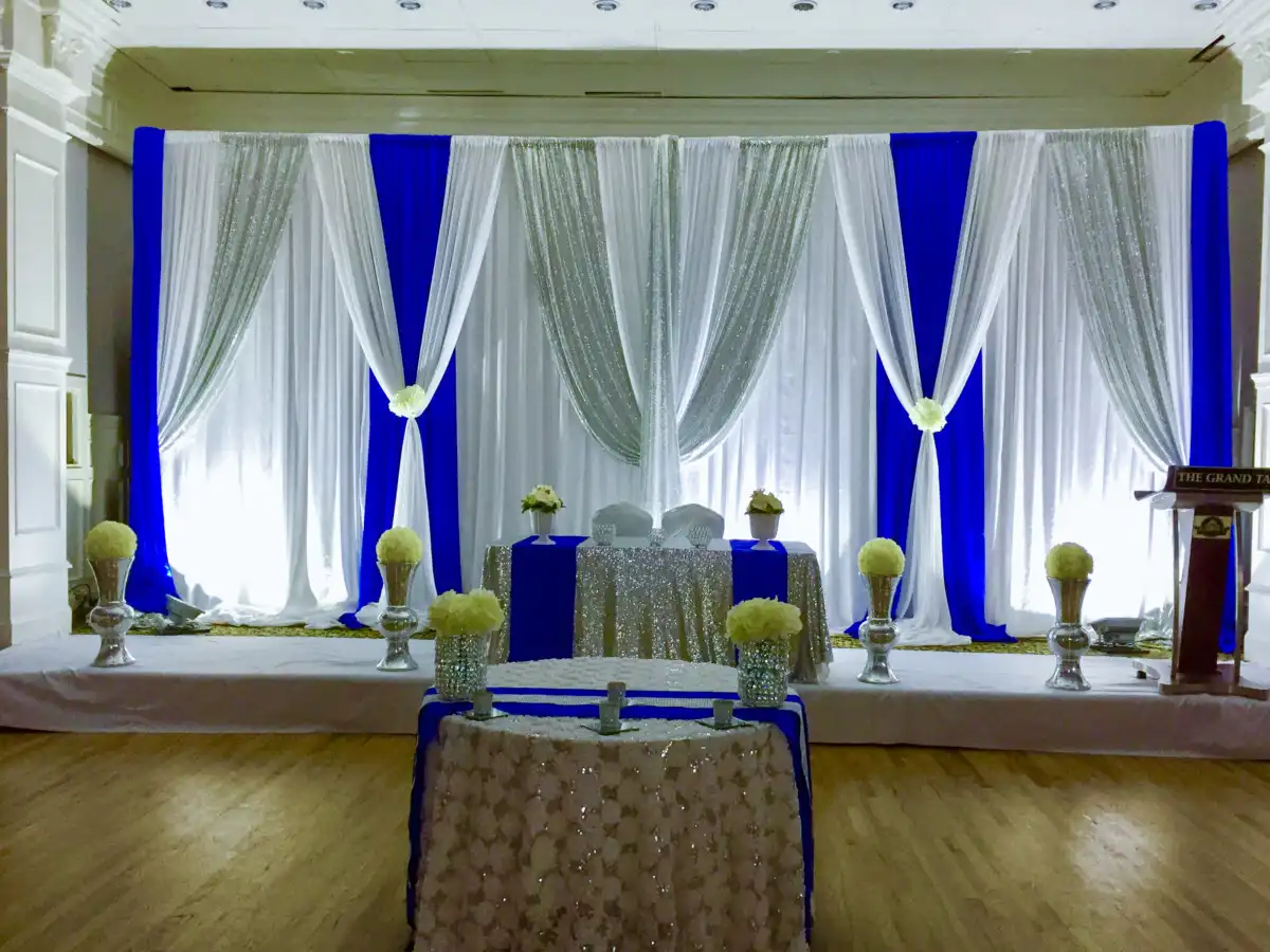 Royal blue and silver sequin reception stage · Dream Decorators