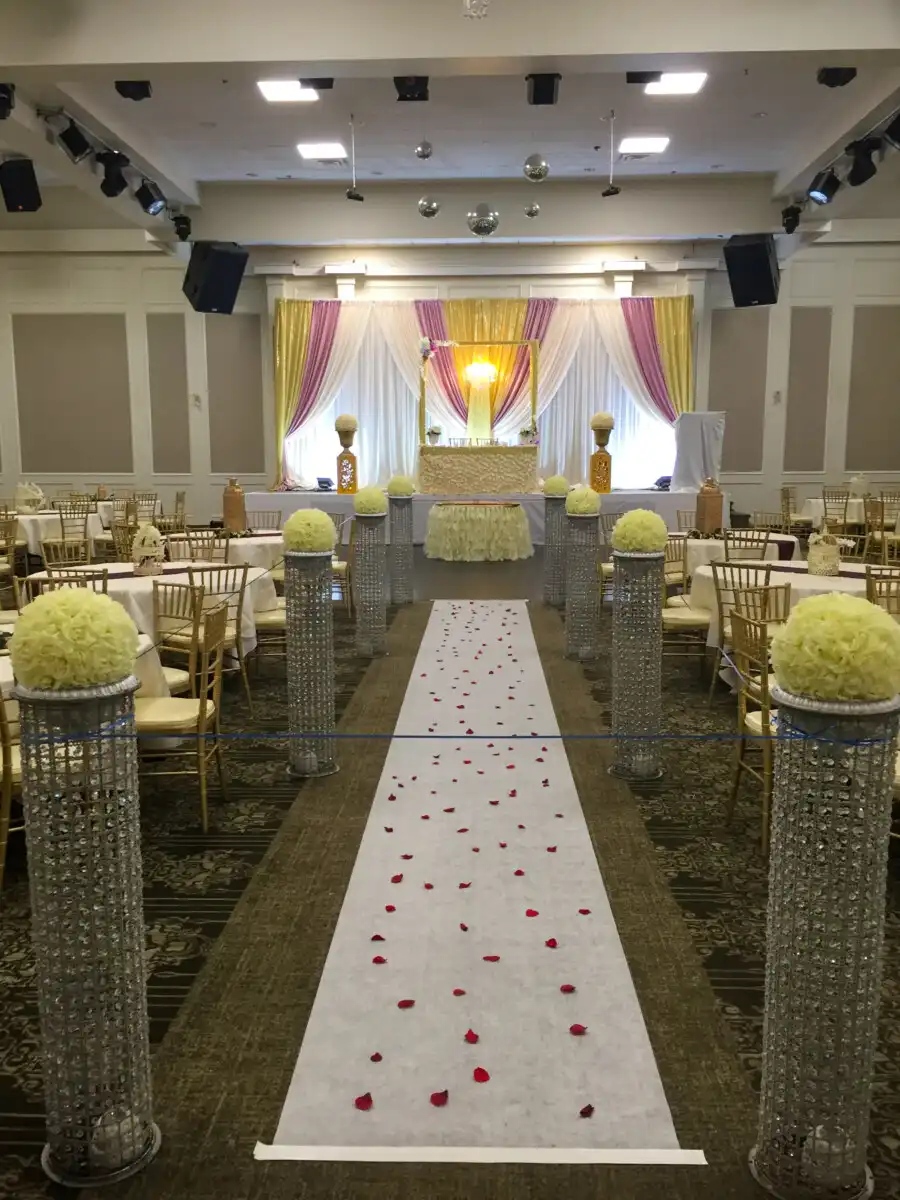 Aisle with crystal pedestals and lavender stage · Dream Decorators Surrey
